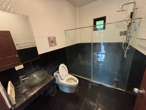 a bathroom with a toilet and a shower and a sink at Unique Paradise Resort in Ban Map Fakthong