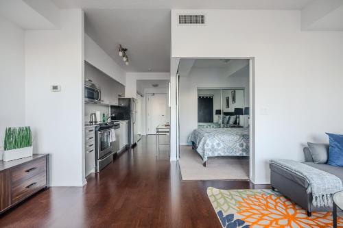 a living room with a bed and a kitchen at High Floor 1 Bedroom Condo City View Downtown Toronto in Toronto