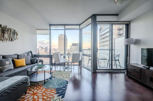 a living room with a couch and a tv at High Floor 1 Bedroom Condo City View Downtown Toronto in Toronto