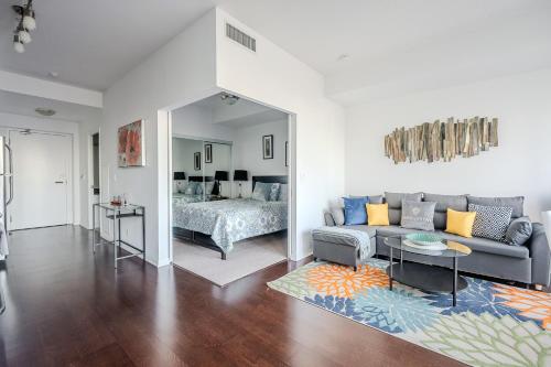 a living room with a couch and a bed at High Floor 1 Bedroom Condo City View Downtown Toronto in Toronto