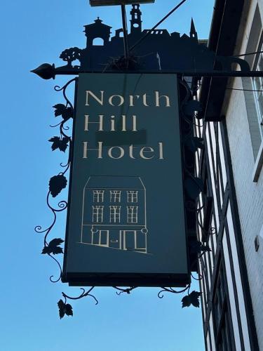 a sign for a hotel hanging on the side of a building at The North Hill Hotel, Colchester in Colchester
