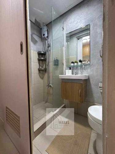 a bathroom with a shower and a sink and a toilet at HabbsVille at Green 2 Residences by SMDC Dasmarinas Cavite in Dasmariñas