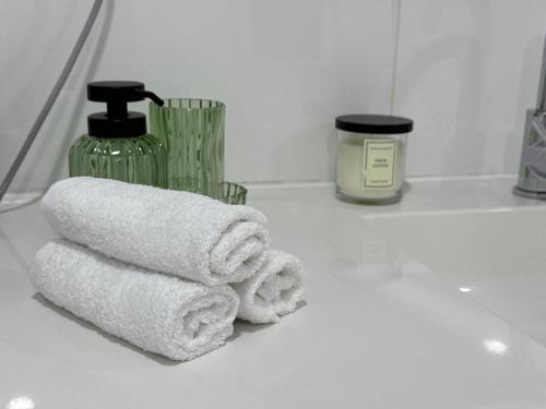 a pile of towels sitting on a bathroom counter at M B Homes Lauterstein 8 in Weißenstein
