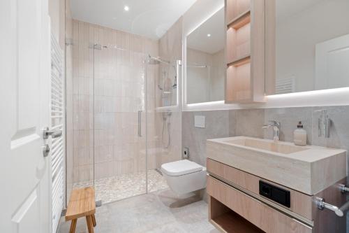 a bathroom with a sink and a toilet and a shower at Alte Schule Westerhever Porrendeich in Westerhever
