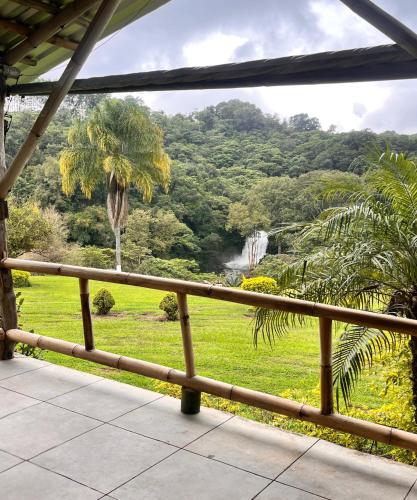 a balcony with a view of a lush green hillside at OYO Hotel Rincon De Texolo in Xico