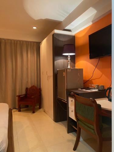 a room with a desk with a computer and a chair at Access Inn Pattaya in Pattaya