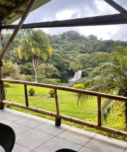 a balcony with a view of a waterfall and trees at OYO Hotel Rincon De Texolo in Xico