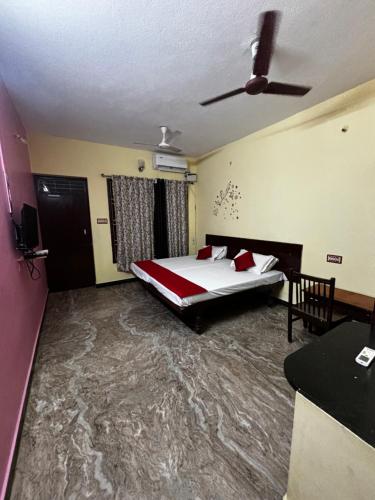 a bedroom with a bed and a ceiling fan at Dreamy beach in Puducherry