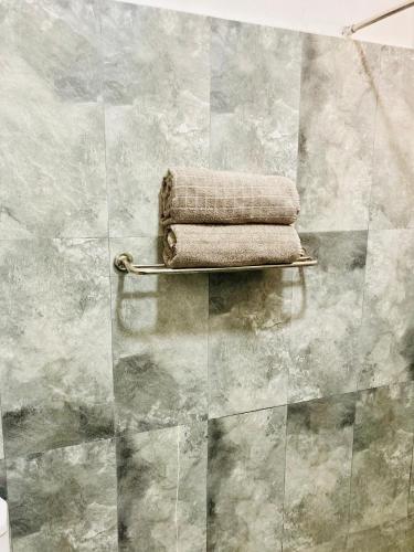 a stack of towels on a towel rack in a bathroom at Hotel 198 Negombo in Negombo
