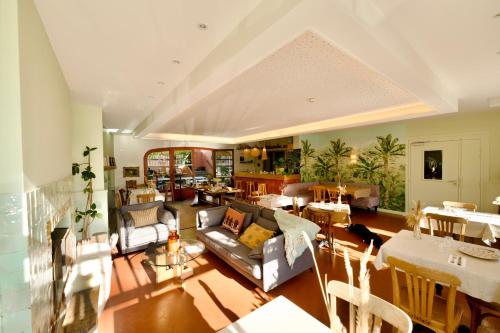 un soggiorno con divano e sala da pranzo di Boutique hôtel Maria-Christina a Saint-Jean-de-Luz