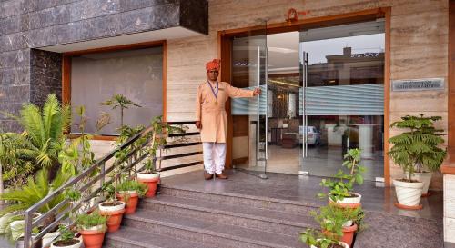 a man standing on the front of a building at Hotel Seven Hills Tower in Agra