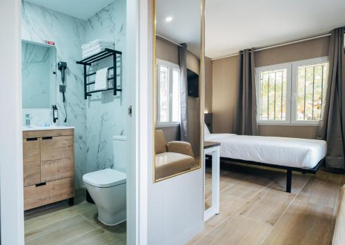 a small room with a bed and a bathroom at Hotel Golden Madrid in Madrid