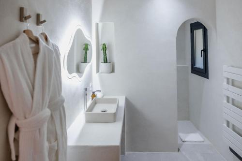a white bathroom with a sink and a mirror at La Bastide de Monique - Maison d'hôtes en Provence in Flassans-sur-Issole