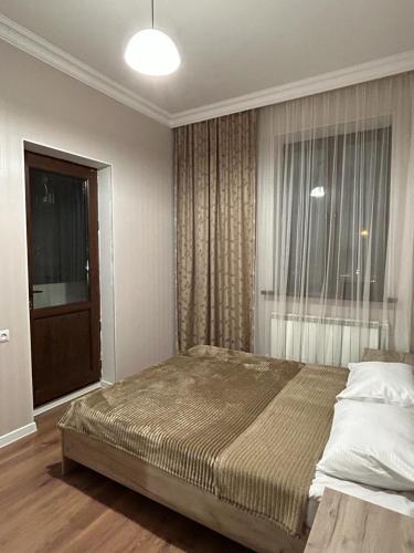 a bedroom with a large bed and a window at АПАРТАМЕНТ 124 у метро in Yerevan