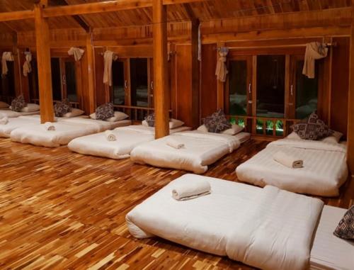 a group of white mattresses lined up in a room at An' Home Mai Chau in Mai Chau