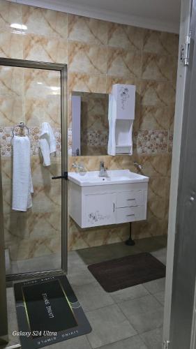 a bathroom with a sink and a shower at FAMILY CLICK HOMEs in Lilongwe