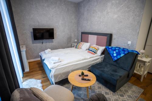 a room with a bed and a chair and a table at Mountain goat Bjelašnica in Bjelašnica