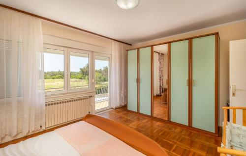 a bedroom with a bed and a large window at Villa Mary by Villas Guide in Jadranovo