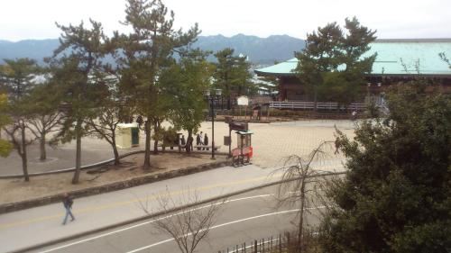 a person walking down a street in a park at Yamaichi Bekkan in Miyajima