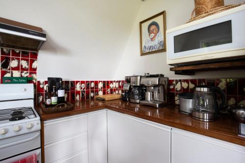 a kitchen with a counter top with a stove and a microwave at Yarra Valley Views in Lilydale