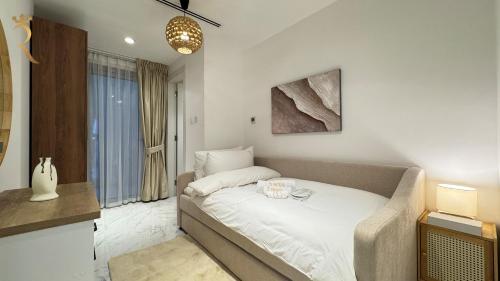 a bedroom with a bed in a room at 2BR Modern Poolside Stay in Masdar City in Abu Dhabi