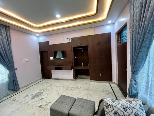 a living room with a couch and a television at harvest haven in Alwar