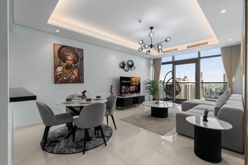 a living room with a couch and a table at Burj Khalifa Downtown Views - Highest Infinity Pool in Downtown in Dubai