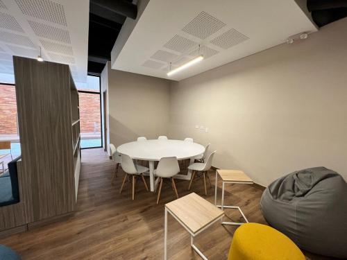 a meeting room with a white table and chairs at Spectacular apartment in the heart of Bogotá! in Bogotá