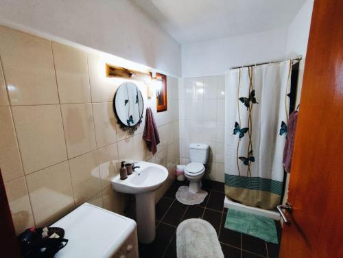a small bathroom with a sink and a toilet at La Casa in Mesinón