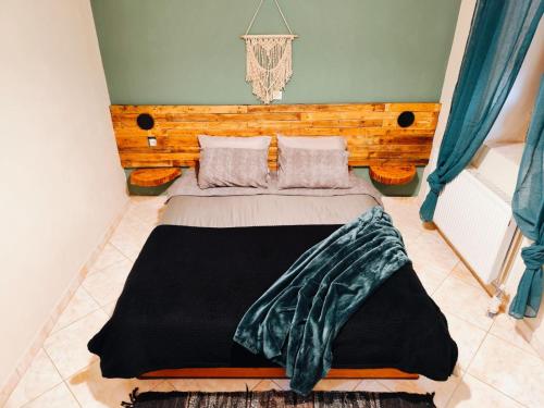 a bedroom with a large bed with a wooden headboard at La Casa in Mesinón