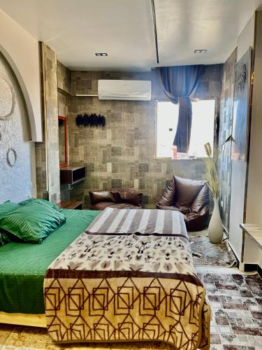 a bedroom with a bed and a couch at Super Elite apartments & Studios - Aswan city center apartments in Aswan
