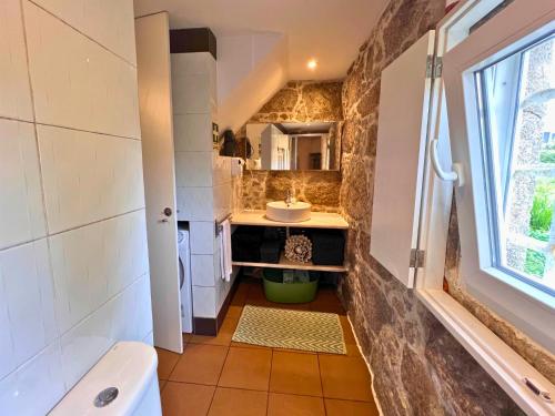 a small bathroom with a sink and a tub at Lourença Stays - Quinta Lourenca in Vilar
