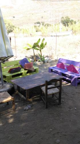 a picnic table with pillows on top of it at Boutique Hotel Tilos Mare in Livadia
