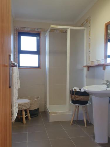 a bathroom with a shower and a sink at Quinta de Natureza in Nabais