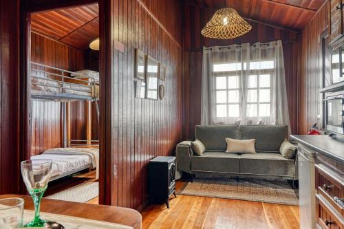 a living room with a couch and a bunk bed at Chalet do Relógio d'Água, a Home in Madeira in Relógio do Poiso