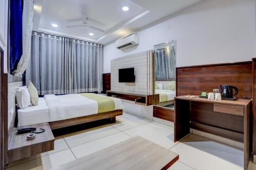 a hotel room with a bed and a television at The Byke Express - Near Gopur Square in Indore
