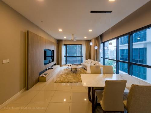 a living room with a dining table and a tv at Luxe Spacious 2br Condo Klcc 600mbps Full Furnish in Kuala Lumpur