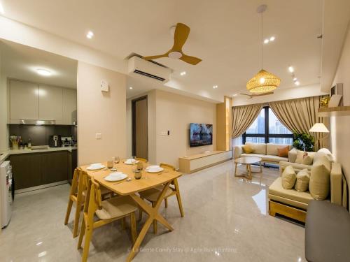a kitchen and living room with a table and a couch at La Gente X Agile Bukit Bintang Trx Pavilion Kl in Kuala Lumpur