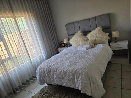 a bedroom with a bed with two stuffed animals on it at Yanaz Place in Germiston