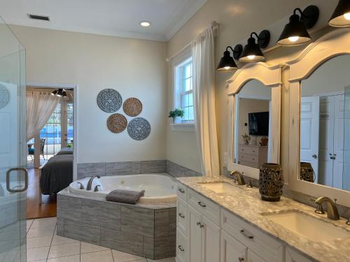 a bathroom with two sinks and a bath tub at Anna Maria Island-Blue Manatee in Bradenton