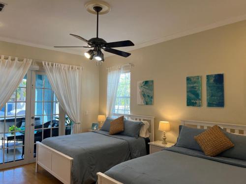 a bedroom with two beds and a ceiling fan at Anna Maria Island-Blue Manatee in Bradenton