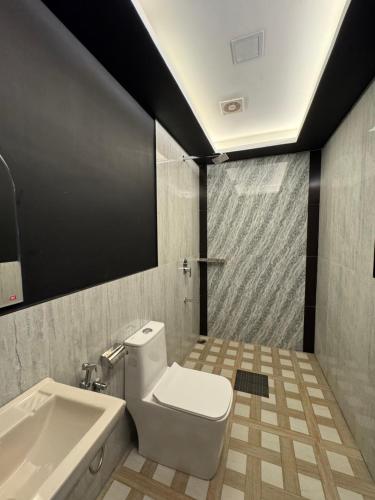 a bathroom with a white toilet and a sink at Kadal beach house marari in Mararikulam