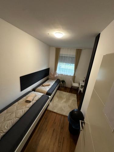 a living room with a couch and a table at Zimmervermietung Wels 2 in Wels