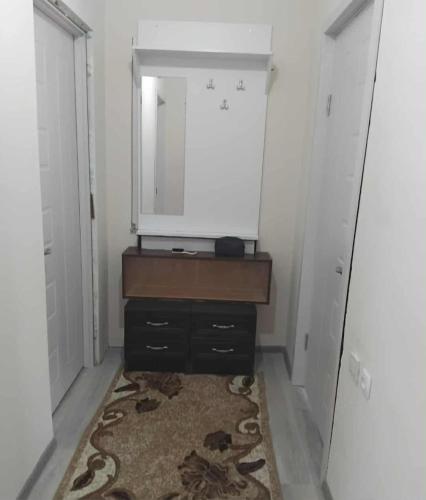 a dressing room with a mirror and a dresser at Khatuna Home in Tsqaltubo