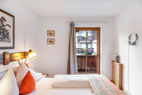 un dormitorio con una cama y una ventana en Wettersteintraum, en Mittenwald