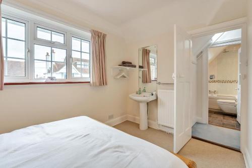a bedroom with a bed and a sink and a bathroom at 3 Bed in Winchelsea oc-t33107 in Winchelsea
