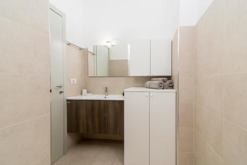 ミラノにあるThe Best Rent - Viale Corsica Apartmentの白いバスルーム(シンク、鏡付)
