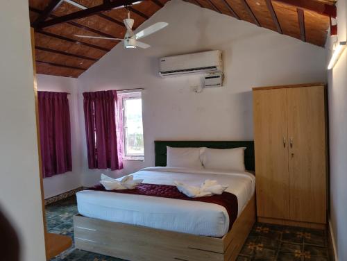 a bedroom with a large bed in a room at Starfalls Eco Beach Resort 