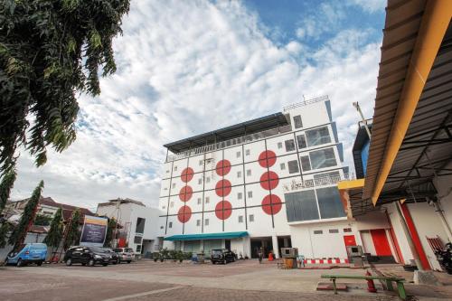 a white building with red circles on the side of it at Sinar Sport Hotel in Bengkulu
