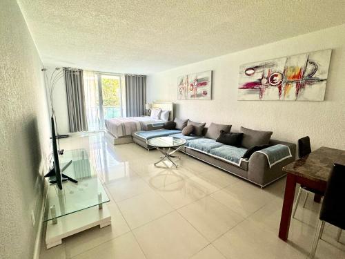 a living room with a couch and a table at Luxury Ocean Reserve Condo Pool, Gym & Beach Access in Sunny Isles Beach